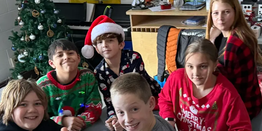 kids around christmas tree in classroom